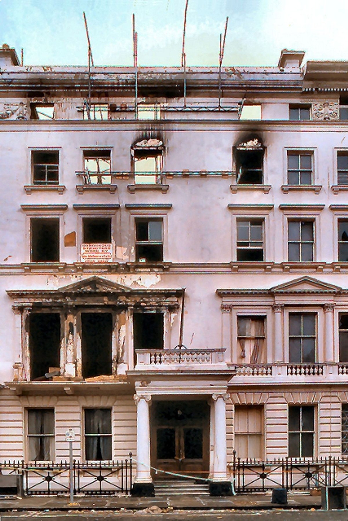Iranian Embassy facade in London on 26 May 1980, with burned windows, scaffolding and visible damage after the siege.