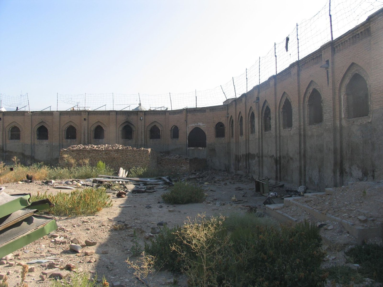 Brick walls and barred openings inside the former Qasr Prison complex in Tehran, photographed before restoration in 2007.