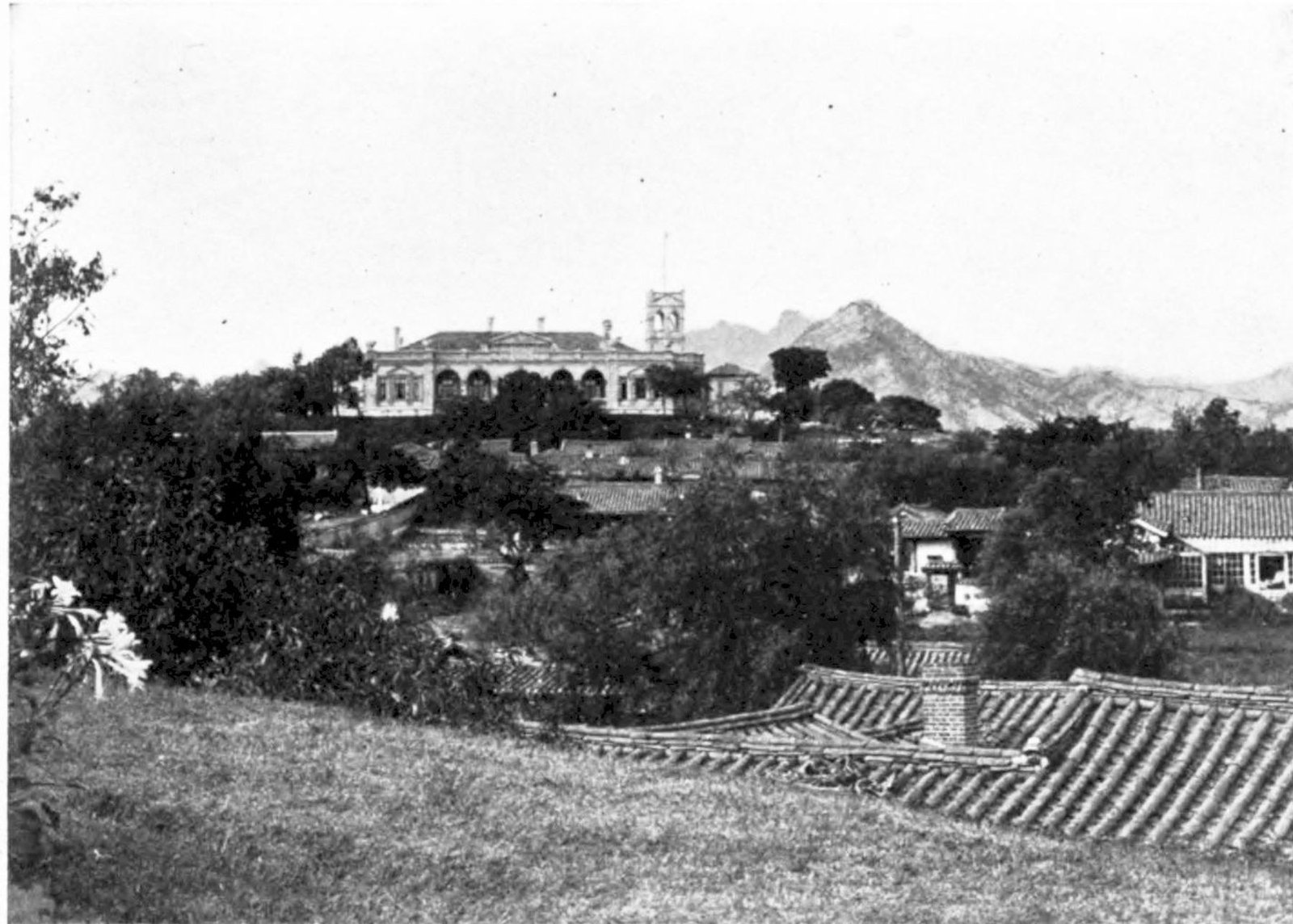 The Russian Legation in Seoul around 1900, standing on a hill above tiled-roof buildings in Jeong-dong.