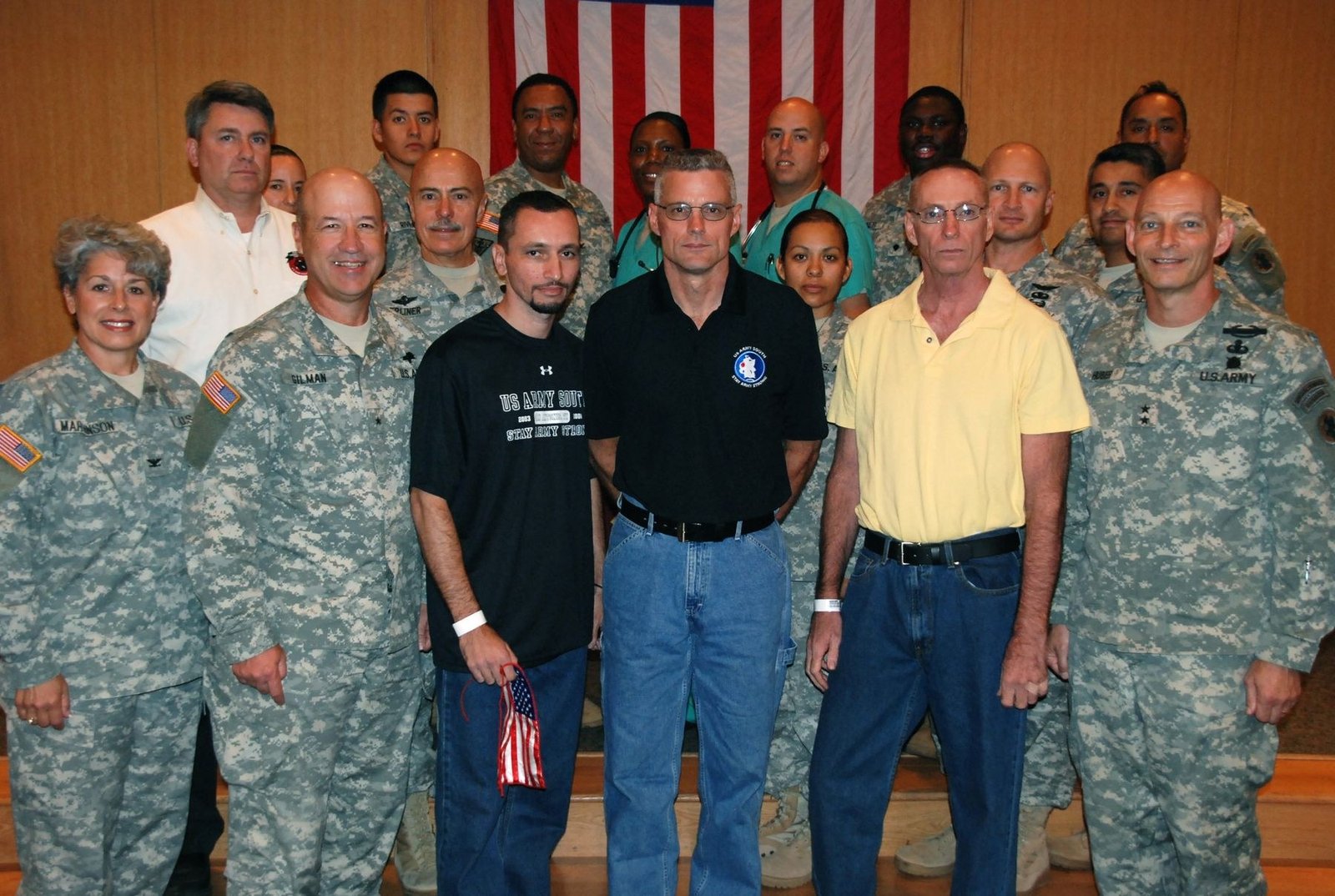 Marc Gonsalves, Keith Stansell and Thomas Howes standing with U.S. Army personnel at Brooke Army Medical Center on July 4, 2008.