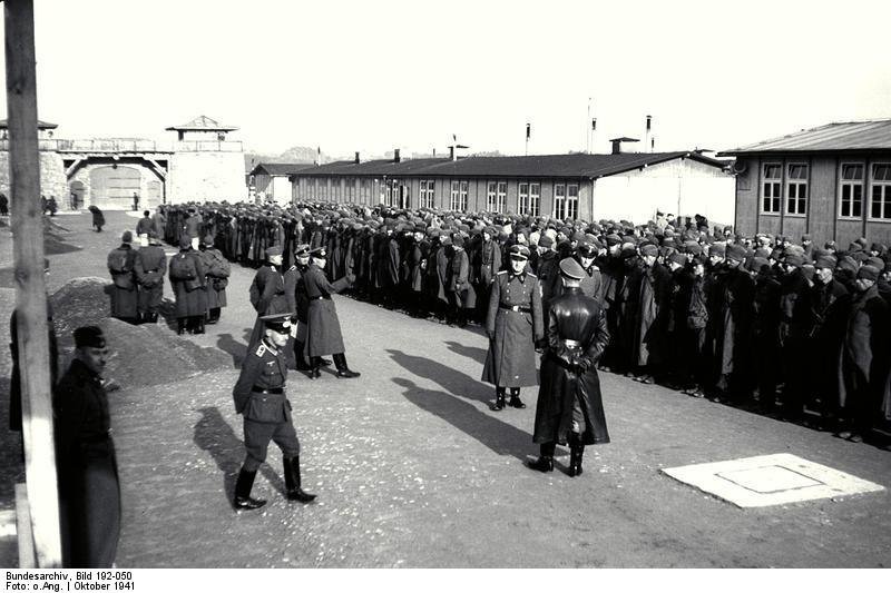 Soviet prisoners of war standing under guard on the Mauthausen concentration camp roll-call square in October 1941.