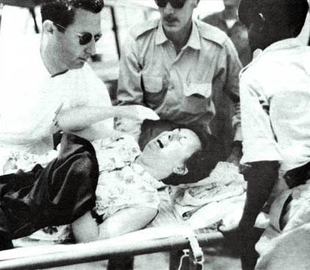 A Belgian civilian evacuee being transported toward a U.S. C-130 at Stanleyville during the November 1964 rescue.
