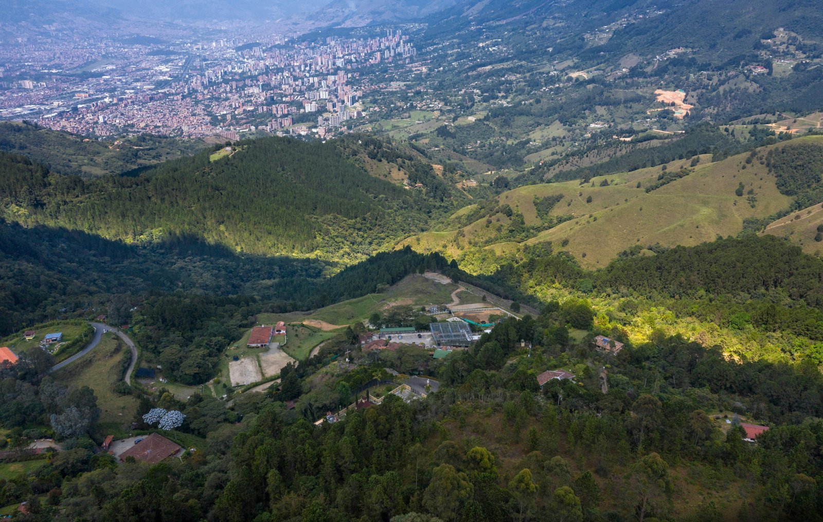 Aerial view of the former La Catedral prison site on a wooded hillside above Envigado, Colombia.