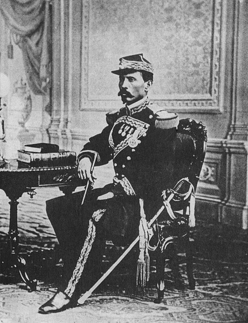 A young Porfirio Díaz sits in military uniform in a nineteenth-century studio portrait.