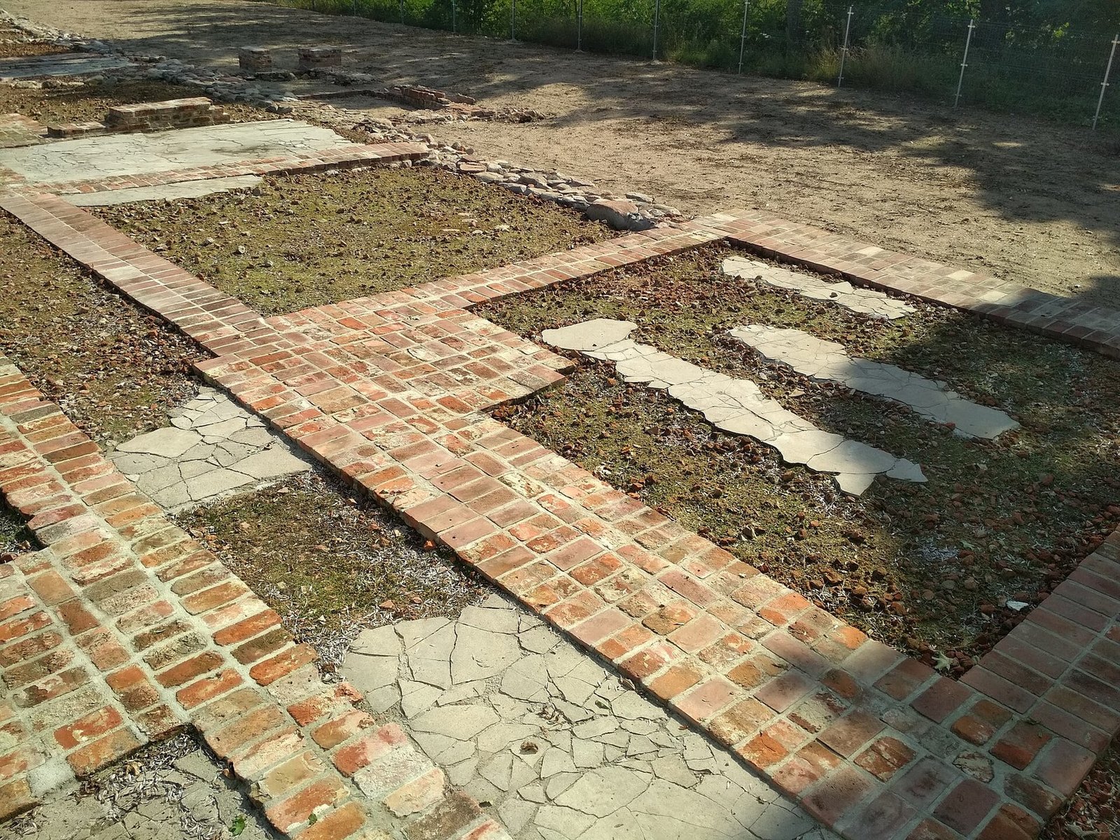 Brick and foundation remains of the former manor complex at the Chełmno killing-center site, photographed in 2020.