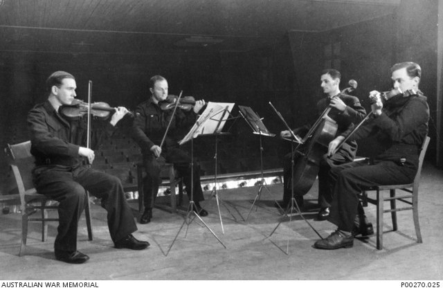 Prisoners rehearsing as a string quartet inside Stalag Luft III North Compound during the Second World War.