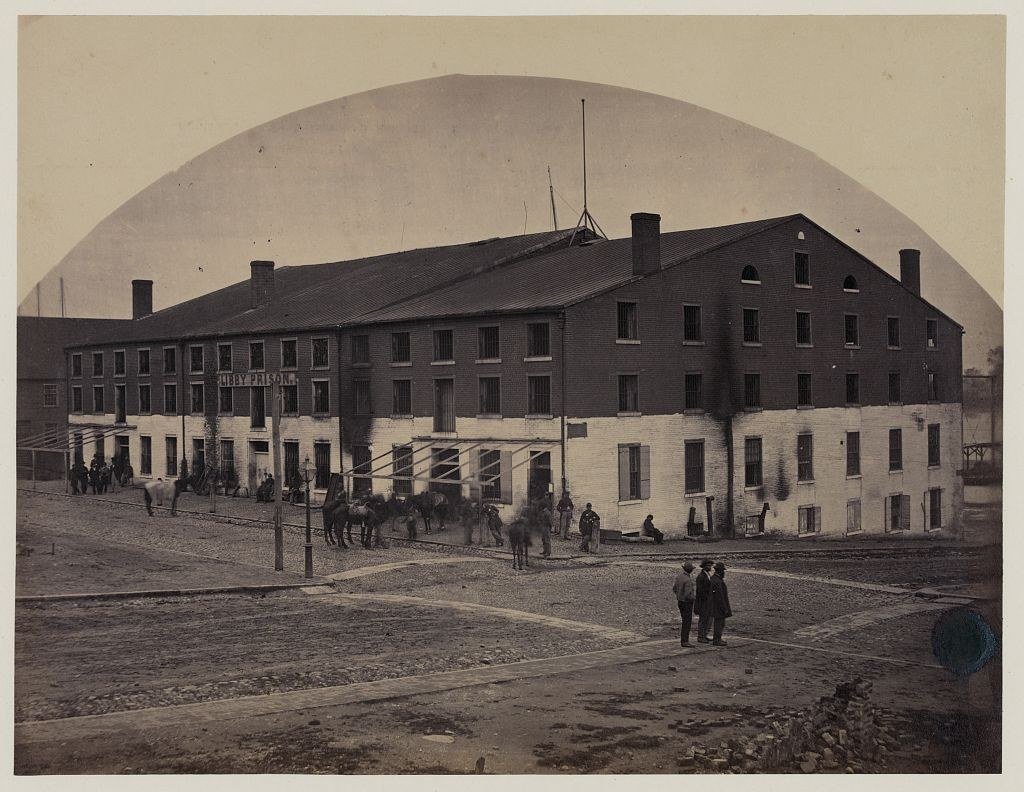 Exterior of Libby Prison in Richmond, Virginia, photographed by Andrew J. Russell in April 1865.