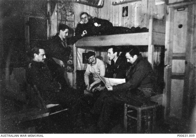 Allied prisoners of war relaxing inside a hut at Stalag Luft III.